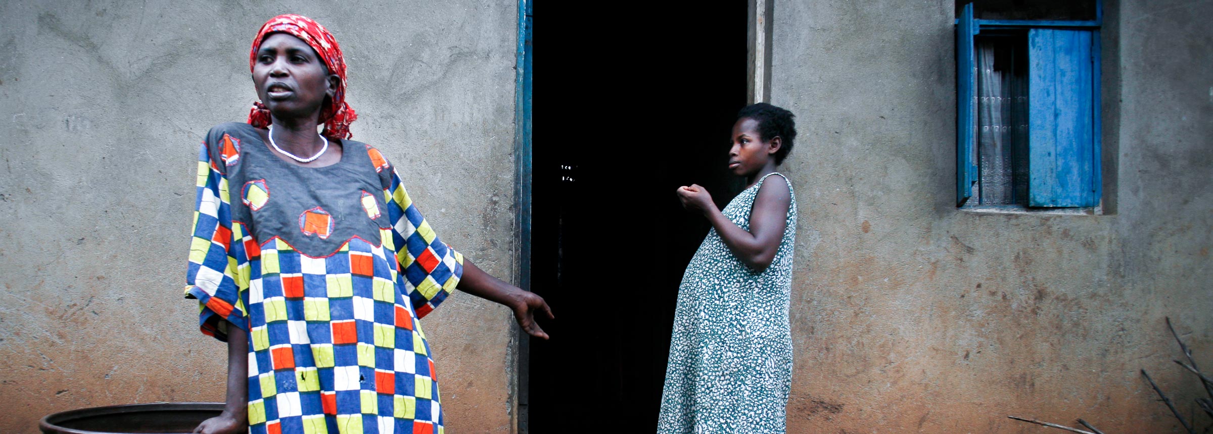 women standing on front stoop of house